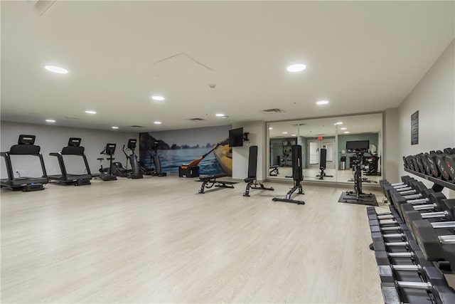 workout area featuring recessed lighting and wood finished floors