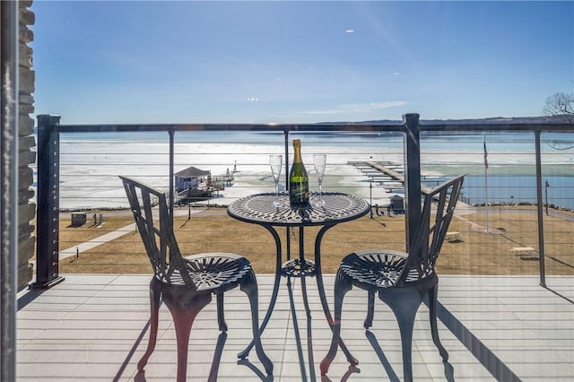 wooden terrace featuring a water view