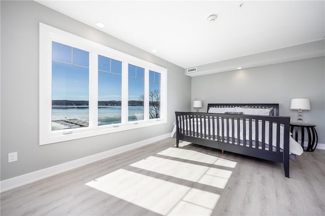 bedroom featuring wood finished floors, recessed lighting, baseboards, and visible vents