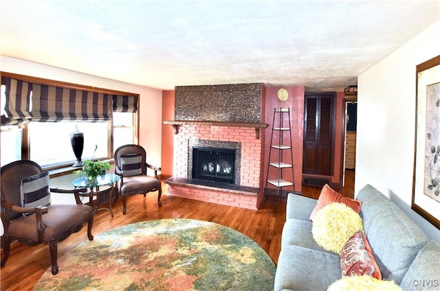 living area with a fireplace and wood finished floors