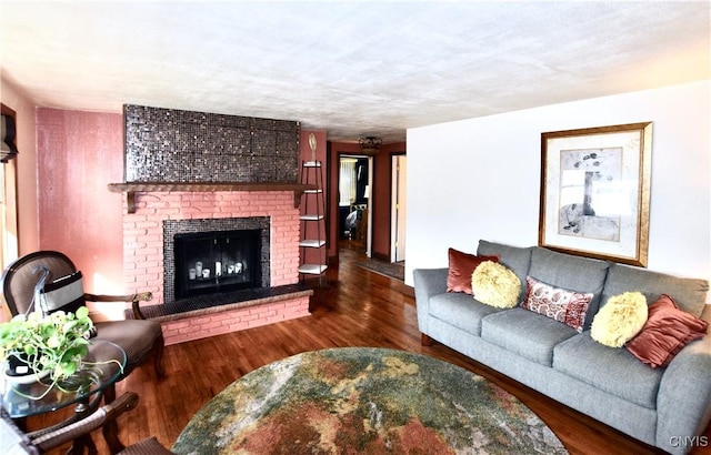 living area featuring a fireplace and wood finished floors