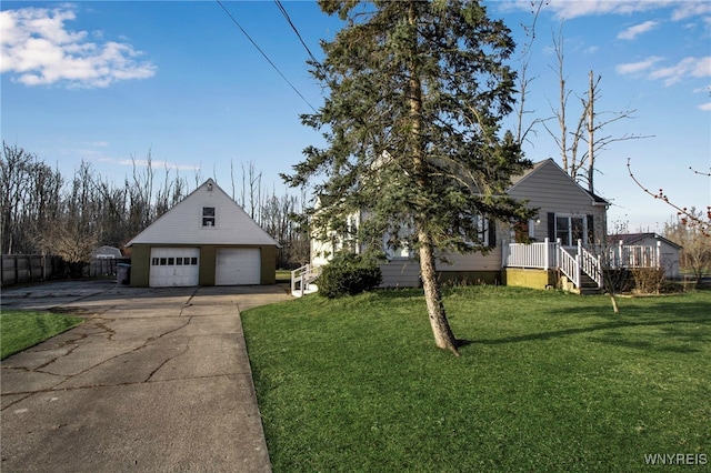 view of front of house with an outbuilding, fence, a wooden deck, a front yard, and a garage