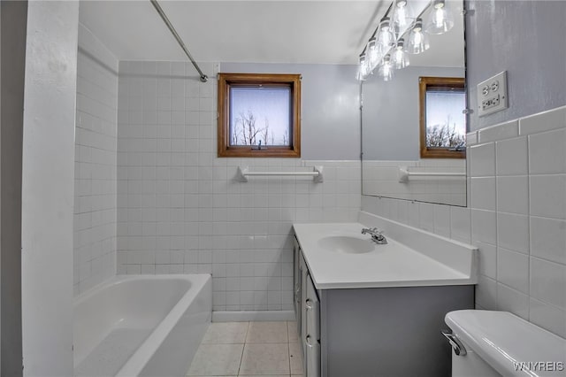 full bathroom featuring tile patterned flooring, vanity, toilet, and tile walls