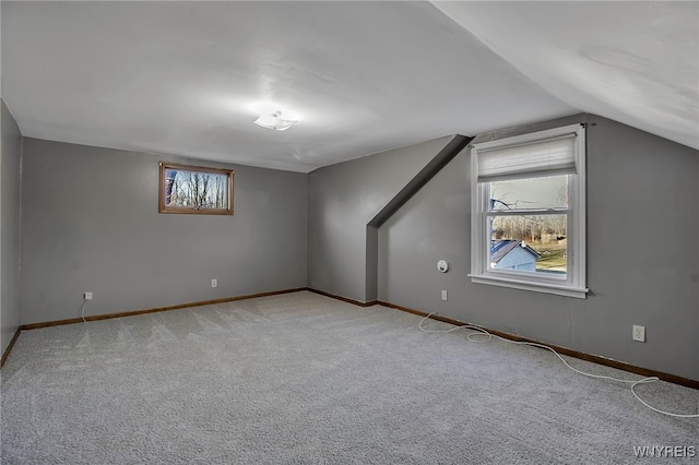 bonus room featuring light colored carpet, baseboards, and lofted ceiling