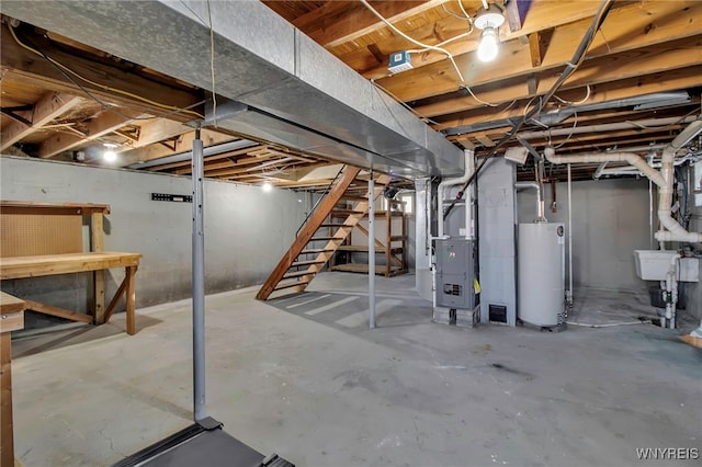 unfinished basement featuring gas water heater and a sink