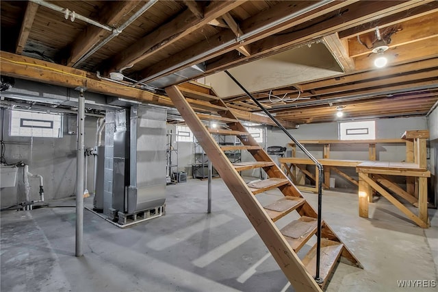 basement featuring heating unit and a healthy amount of sunlight