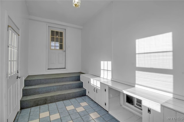 staircase featuring crown molding and a wealth of natural light