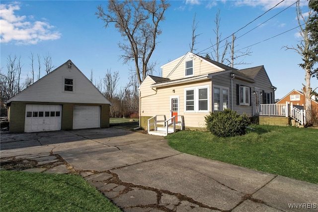 view of property exterior featuring a detached garage, a lawn, and an outdoor structure