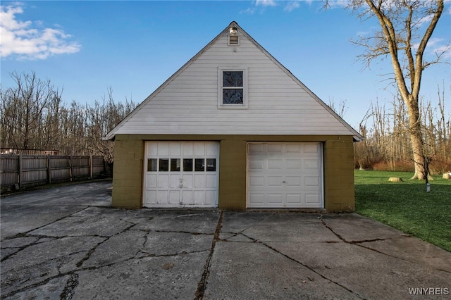 garage featuring a garage and fence