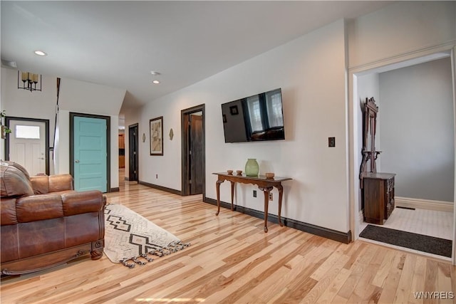 living area with light wood finished floors, recessed lighting, and baseboards