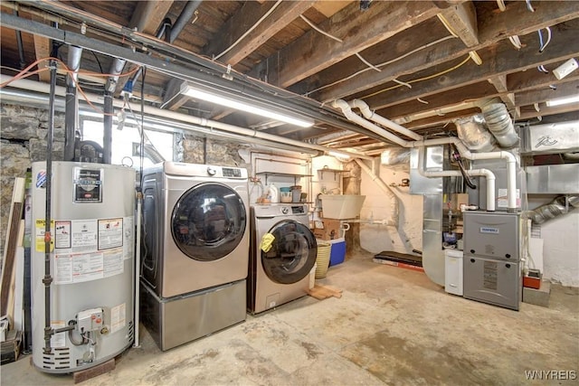 unfinished below grade area featuring washer and dryer, water heater, and a sink