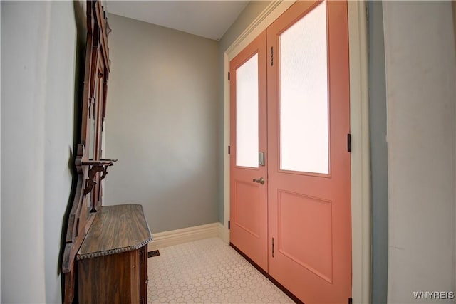 foyer entrance featuring baseboards