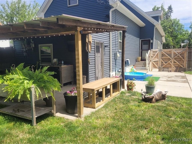 view of home's exterior with a gate, a yard, a deck, and fence