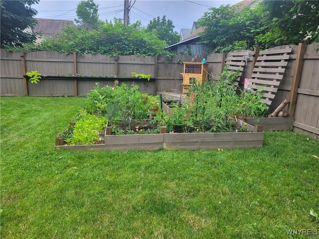 view of yard featuring fence and a garden