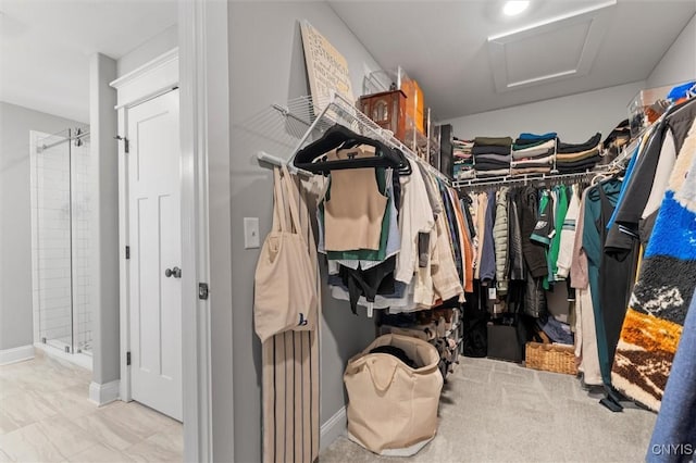 walk in closet featuring attic access