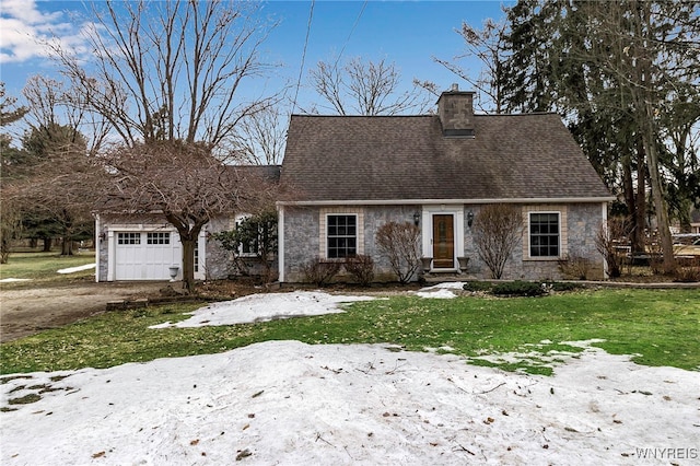 cape cod house featuring a front lawn, roof with shingles, a chimney, stone siding, and an attached garage