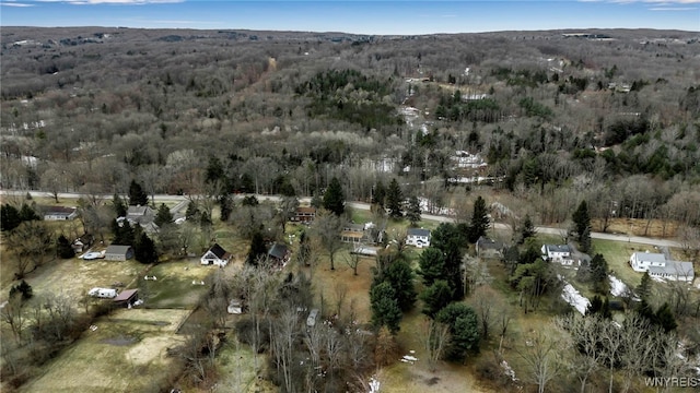 drone / aerial view featuring a wooded view