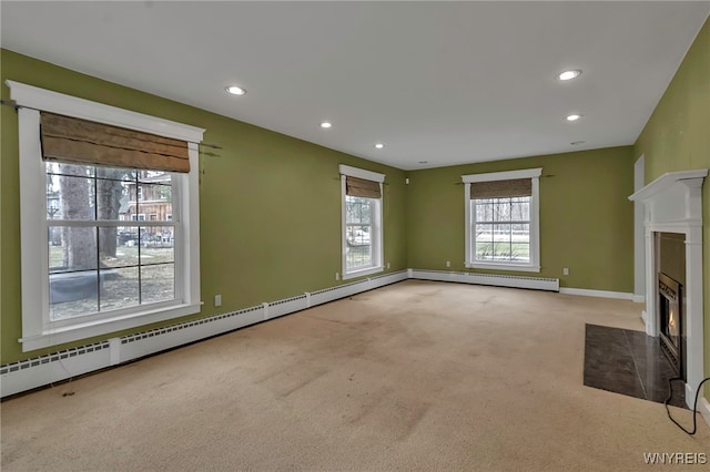 unfurnished living room featuring carpet flooring, a fireplace with flush hearth, recessed lighting, and baseboards