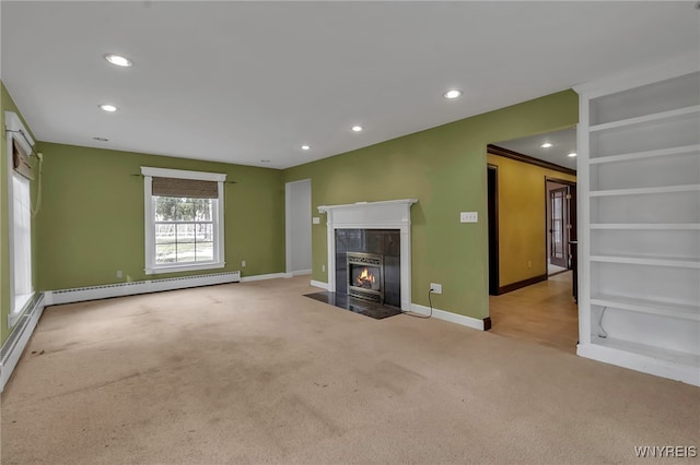 unfurnished living room featuring recessed lighting, baseboard heating, carpet, and a tile fireplace