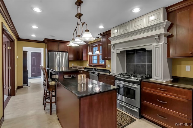 kitchen with a breakfast bar area, a kitchen island, recessed lighting, ornamental molding, and appliances with stainless steel finishes