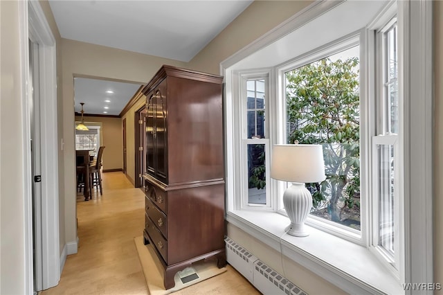 hallway featuring baseboard heating and baseboards