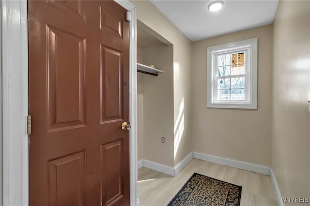 foyer with baseboards and light wood finished floors