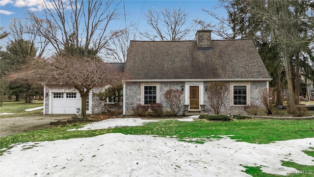 cape cod house featuring stone siding, a chimney, an attached garage, and a shingled roof