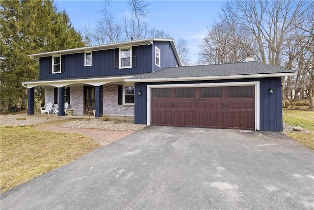 traditional home featuring driveway, covered porch, a shingled roof, a garage, and brick siding