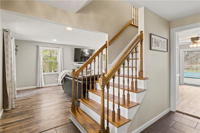 stairway featuring recessed lighting, baseboards, and wood finished floors