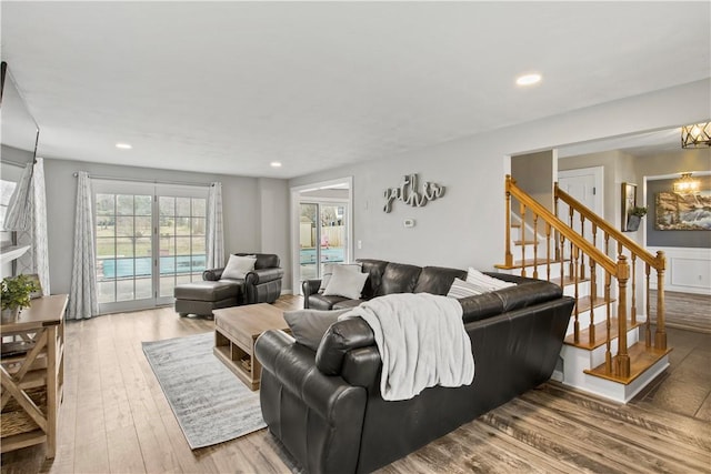 living area featuring stairway, recessed lighting, and wood finished floors