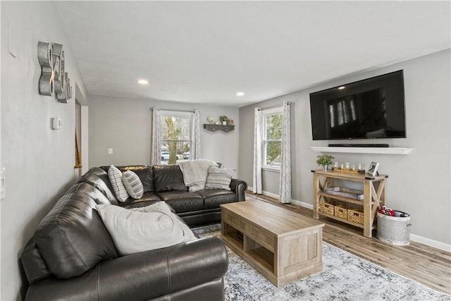 living area with recessed lighting, wood finished floors, and baseboards