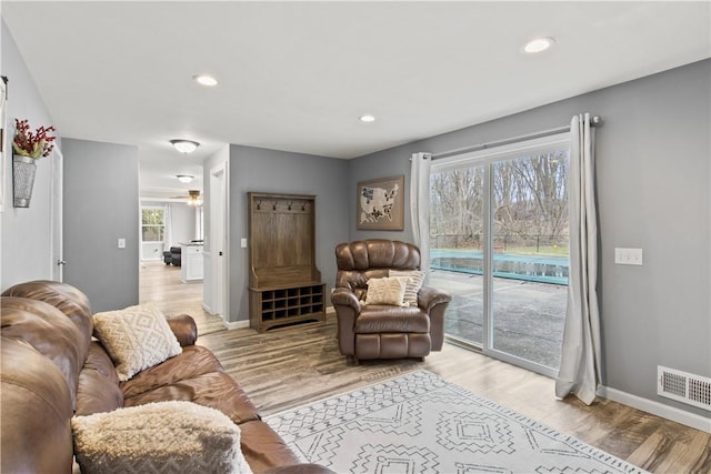 living room with light wood-style floors, recessed lighting, a healthy amount of sunlight, and visible vents