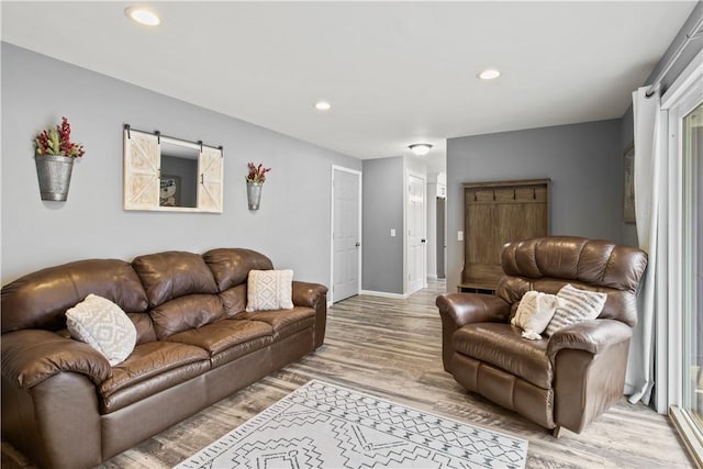 living room with recessed lighting, light wood-style floors, and baseboards