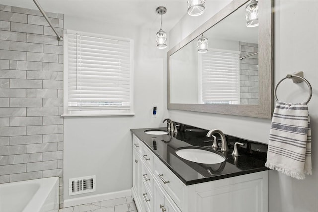 full bathroom featuring a sink, visible vents, baseboards, and marble finish floor