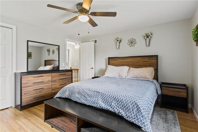 bedroom with visible vents, light wood-style floors, and ceiling fan