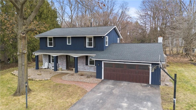 traditional home with a front lawn, a porch, roof with shingles, driveway, and an attached garage