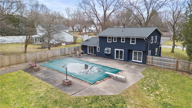 view of swimming pool featuring a yard, a patio area, a fenced in pool, and a fenced backyard