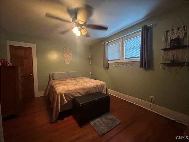 bedroom featuring baseboards, wood finished floors, and a ceiling fan