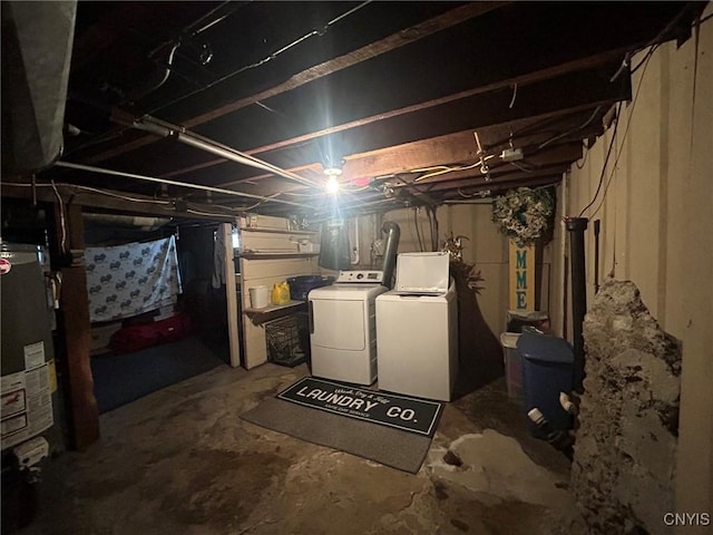 unfinished basement with gas water heater and washing machine and clothes dryer