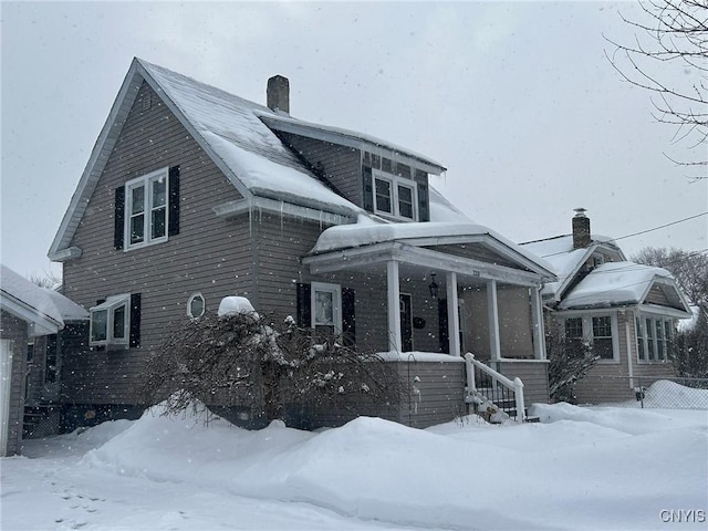 exterior space with a porch and a chimney