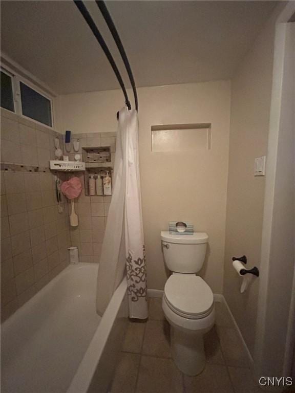 full bathroom with tile patterned floors, baseboards, toilet, and shower / bath combination with curtain