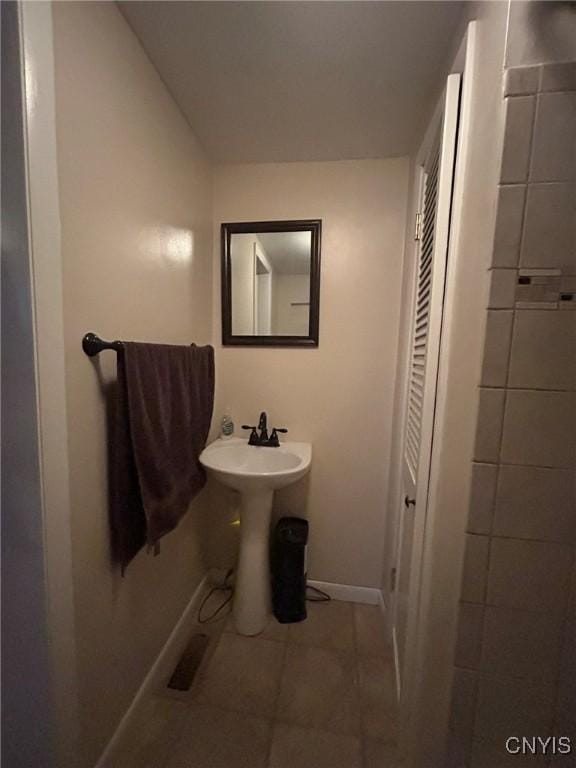 bathroom with tile patterned floors and baseboards