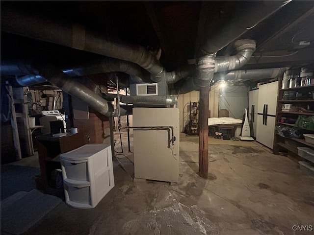 unfinished basement with heating unit and visible vents