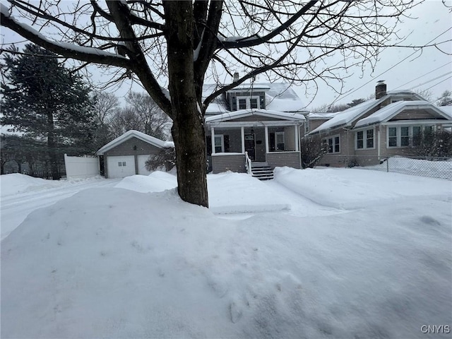 view of front of home featuring an outbuilding and fence