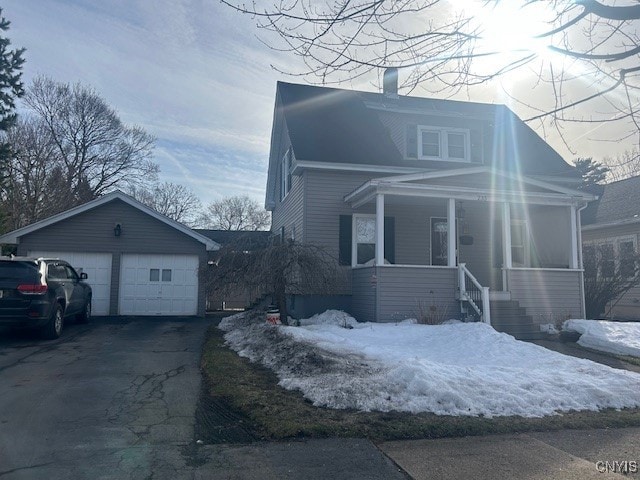 view of front of house with a garage, a porch, and a chimney