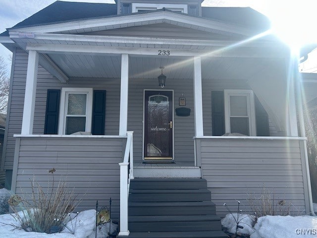 view of exterior entry featuring a porch