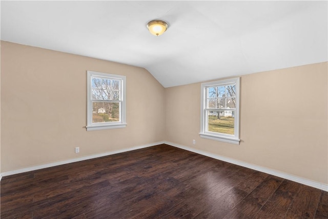 bonus room featuring vaulted ceiling, baseboards, and wood finished floors