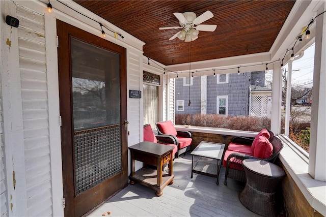 sunroom with a ceiling fan, vaulted ceiling, and wood ceiling