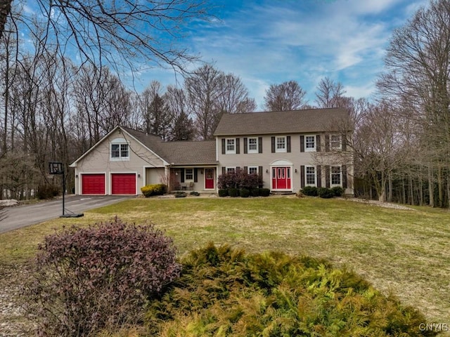 colonial home with driveway and a front yard