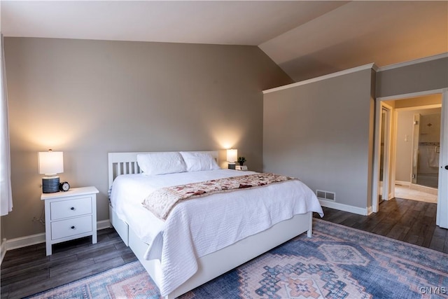 bedroom featuring vaulted ceiling, wood finished floors, visible vents, and baseboards